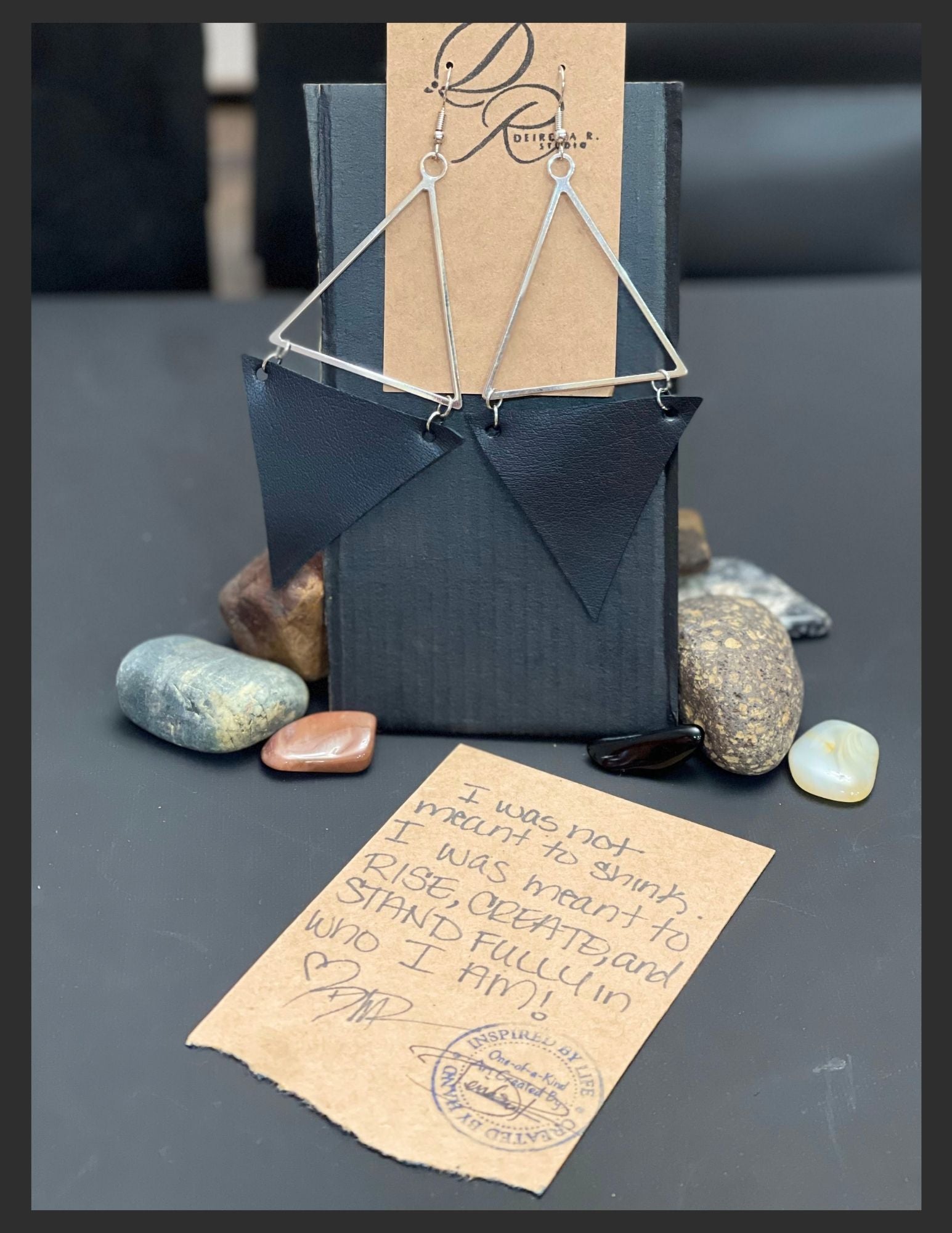 Silver colored metal triangles with black leather
